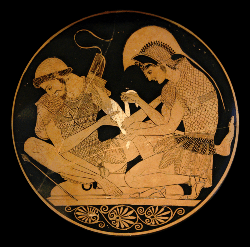 Tondo of an Attic Red-Figure Kylix, ca. 500 BCE, depicting Achilles tending Patroklos' arm, wounded by an arrow. Source: Wikimedia Commons